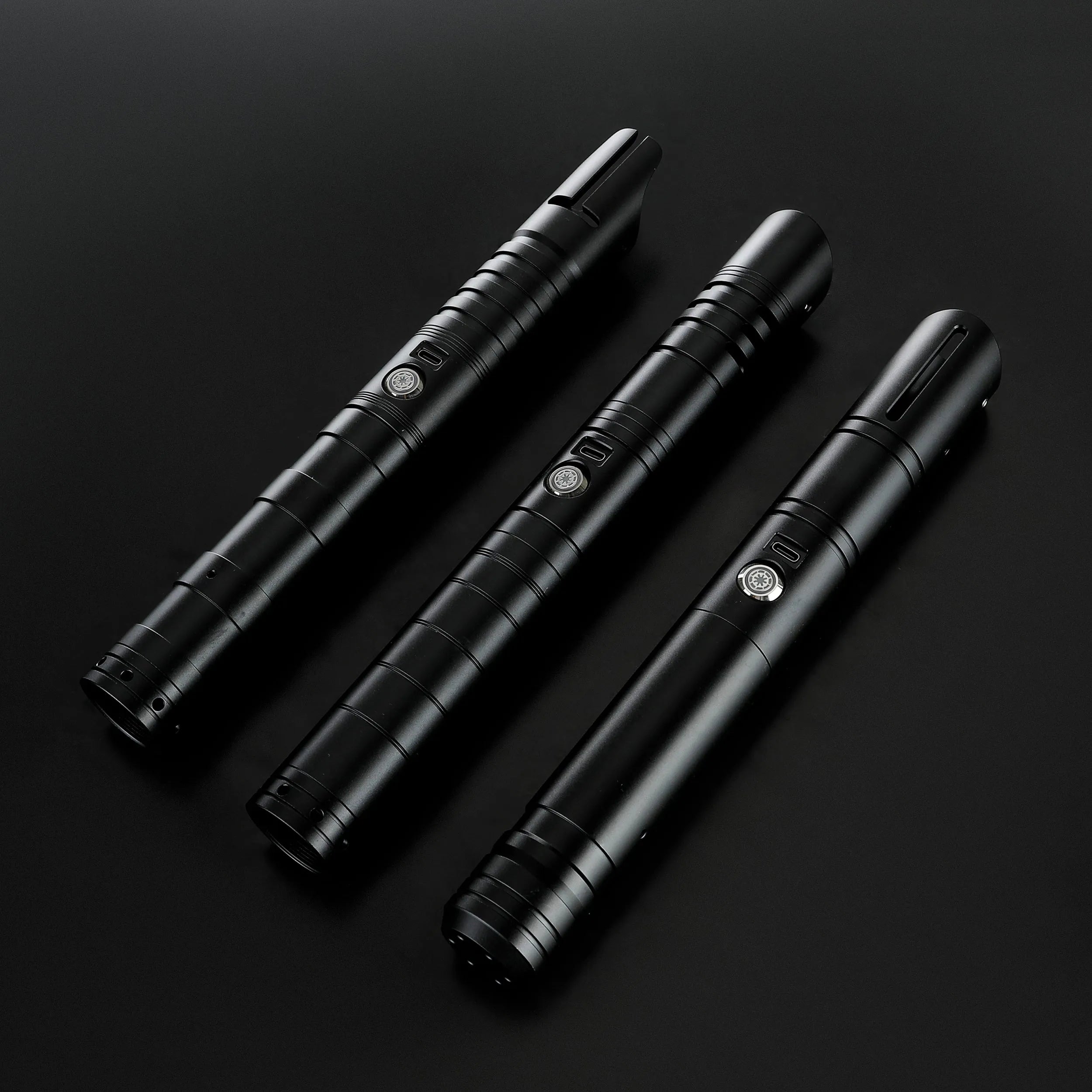 Three black T6 aluminum alloy dueling sabers: Defender, Hunter, and Enforcer 2, with silver buttons.