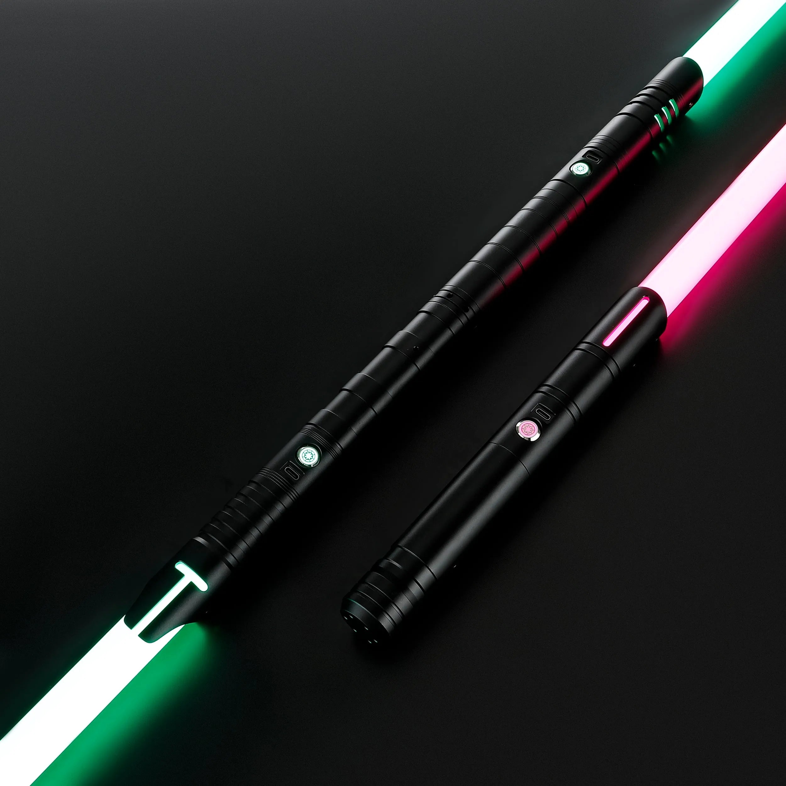 Two black T6 aluminum alloy dueling sabers, one with a green and white blade, the other with a pink blade.