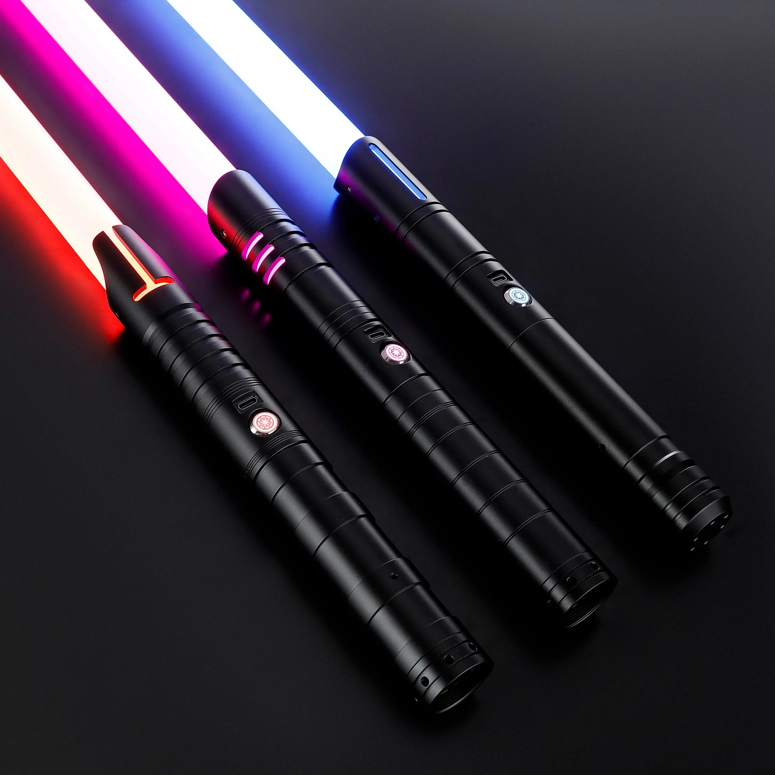Three black T6 Aluminum Alloy dueling sabers with glowing red, pink, and blue blades.