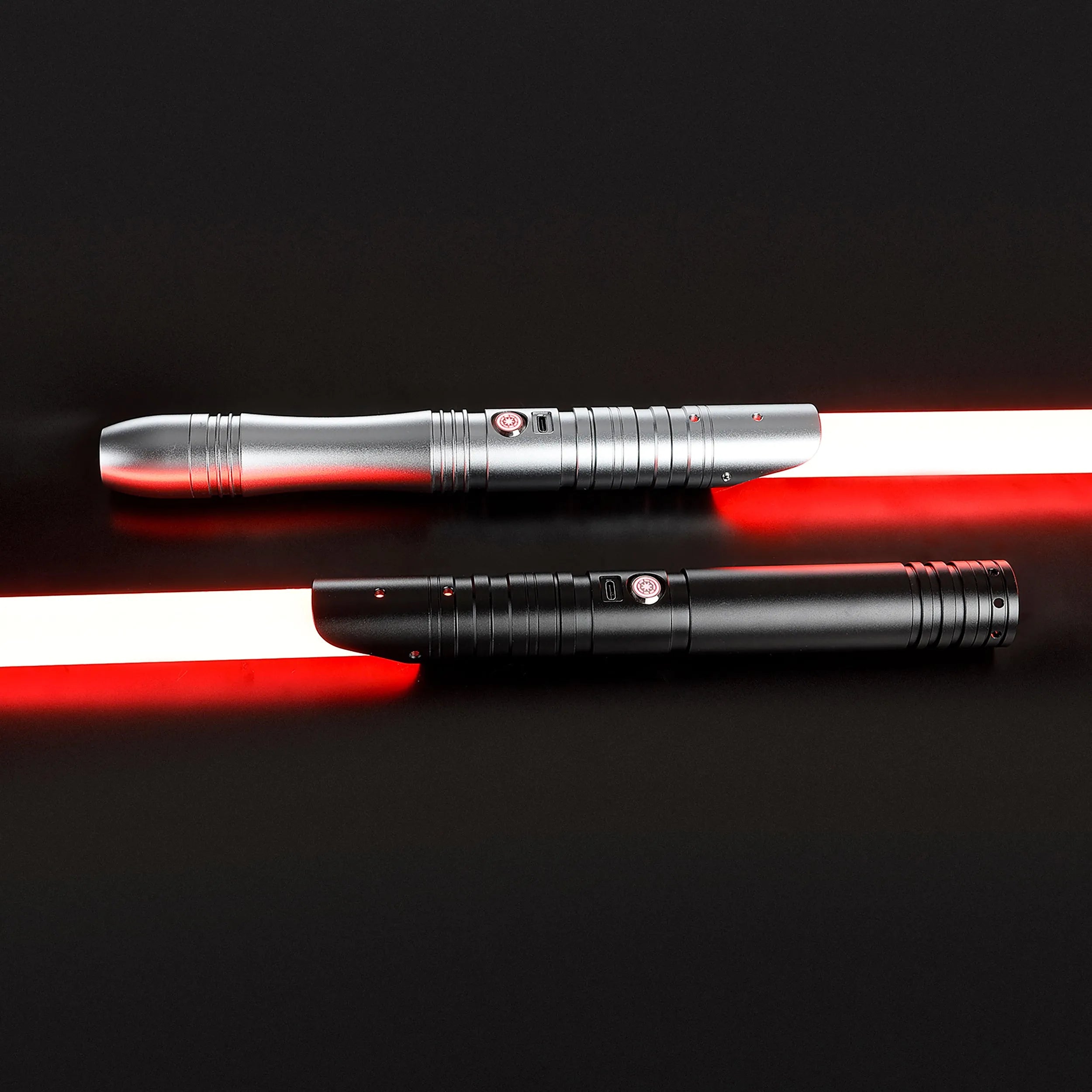 Father & Son Saber Bundle: Two aluminum hilt sabers, one silver and one black, with glowing red baselit blades.