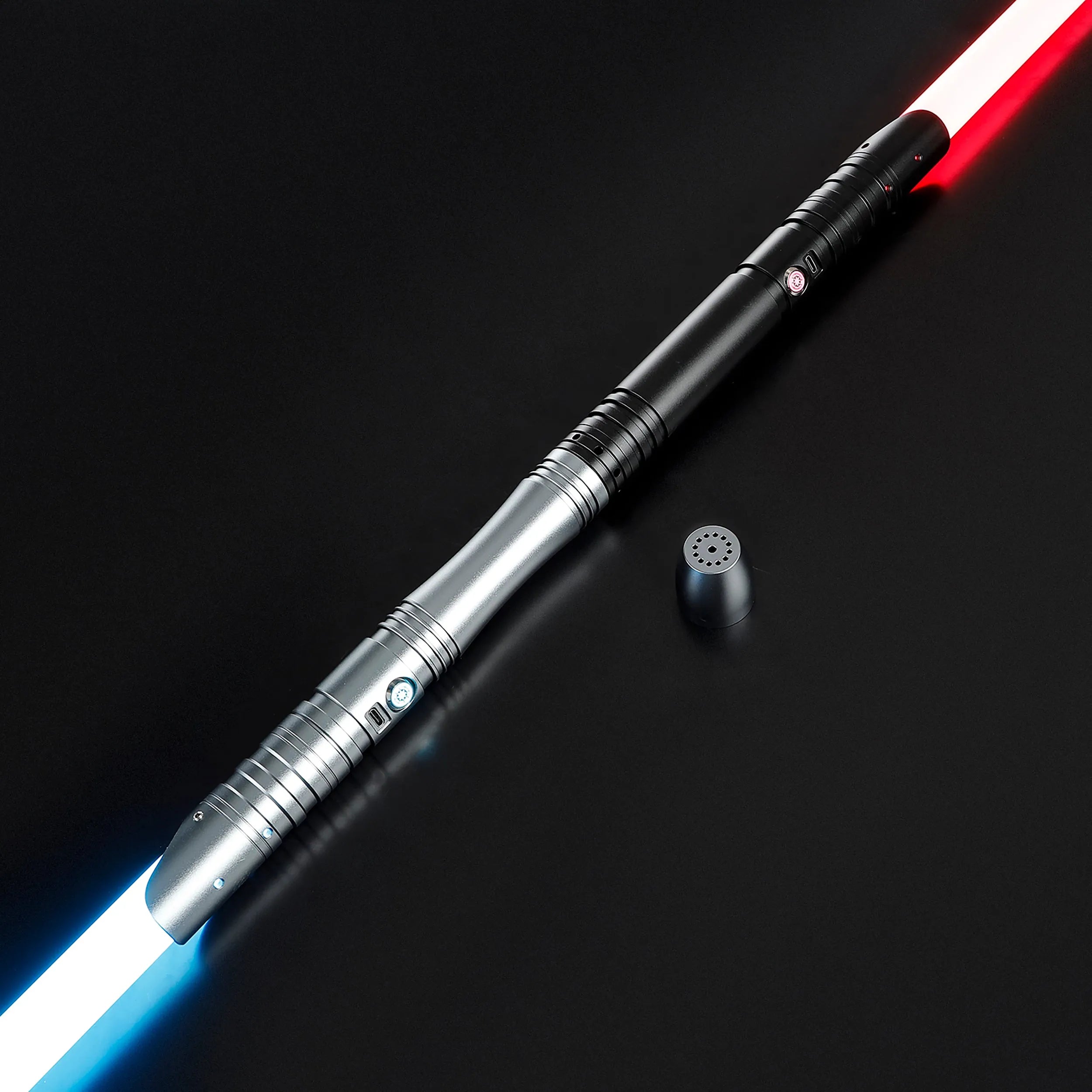 Two duel-ready sabers, one with a red blade and one with a blue blade, featuring black and silver aluminum hilts.