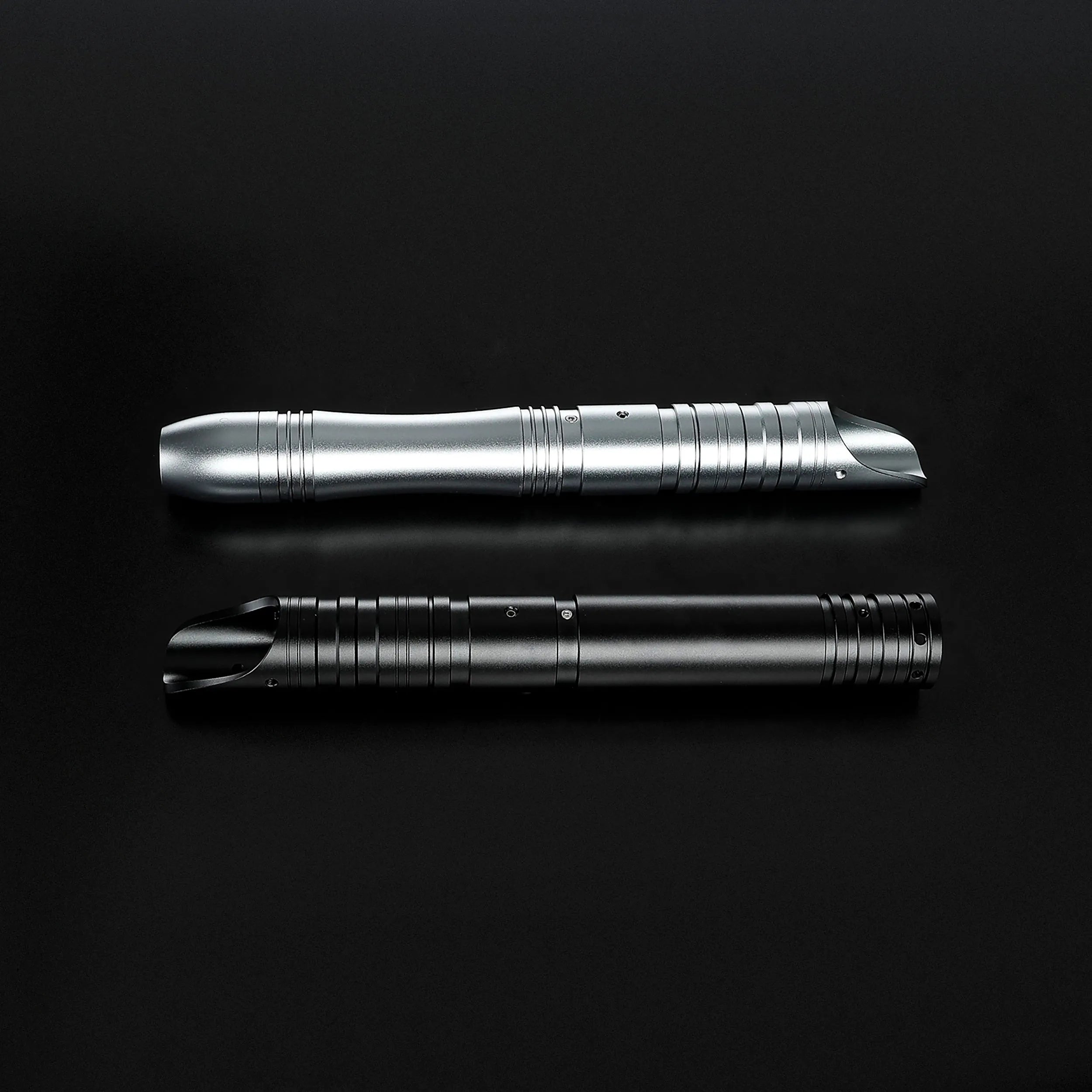 Father & Son Saber Bundle: a silver and a black aluminum hilt, both with ribbed grips and angled emitters.