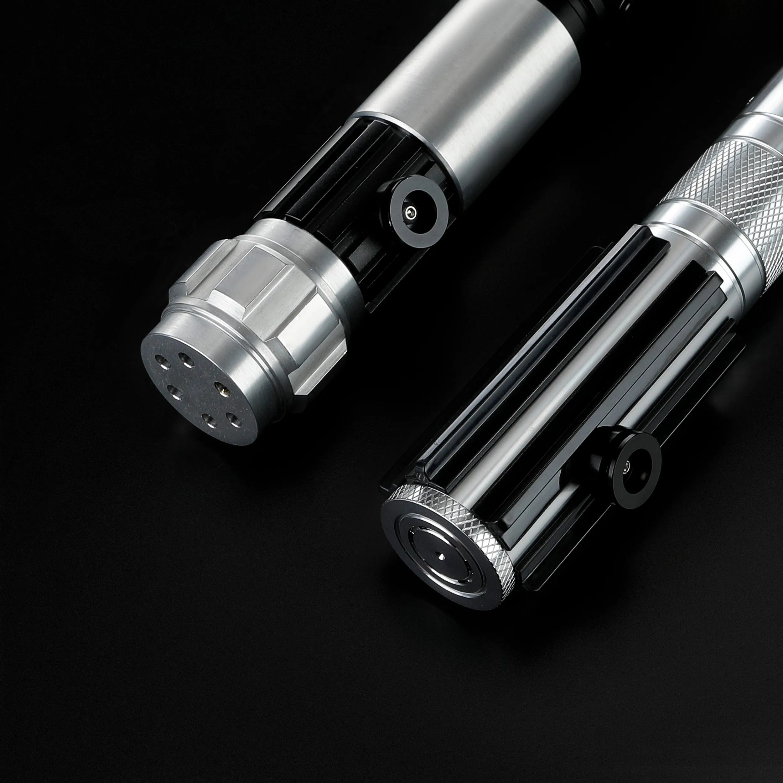 Two T6 aluminum alloy Obi-Wan and Anakin lightsaber hilts with black and silver detailing on a black background.