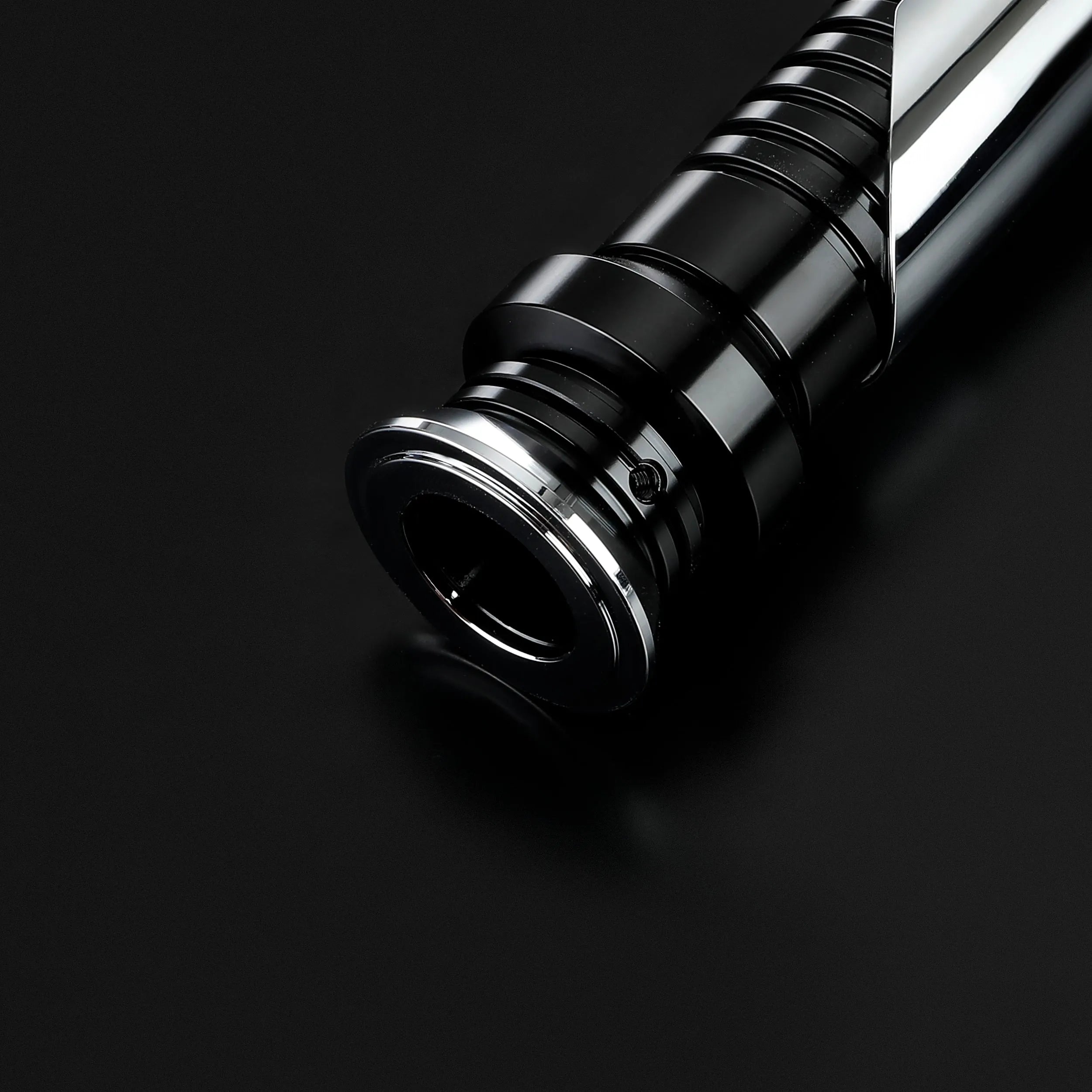 Qui-Gon Jinn lightsaber hilt, black T60 aluminum with silver accents, on a dark background.