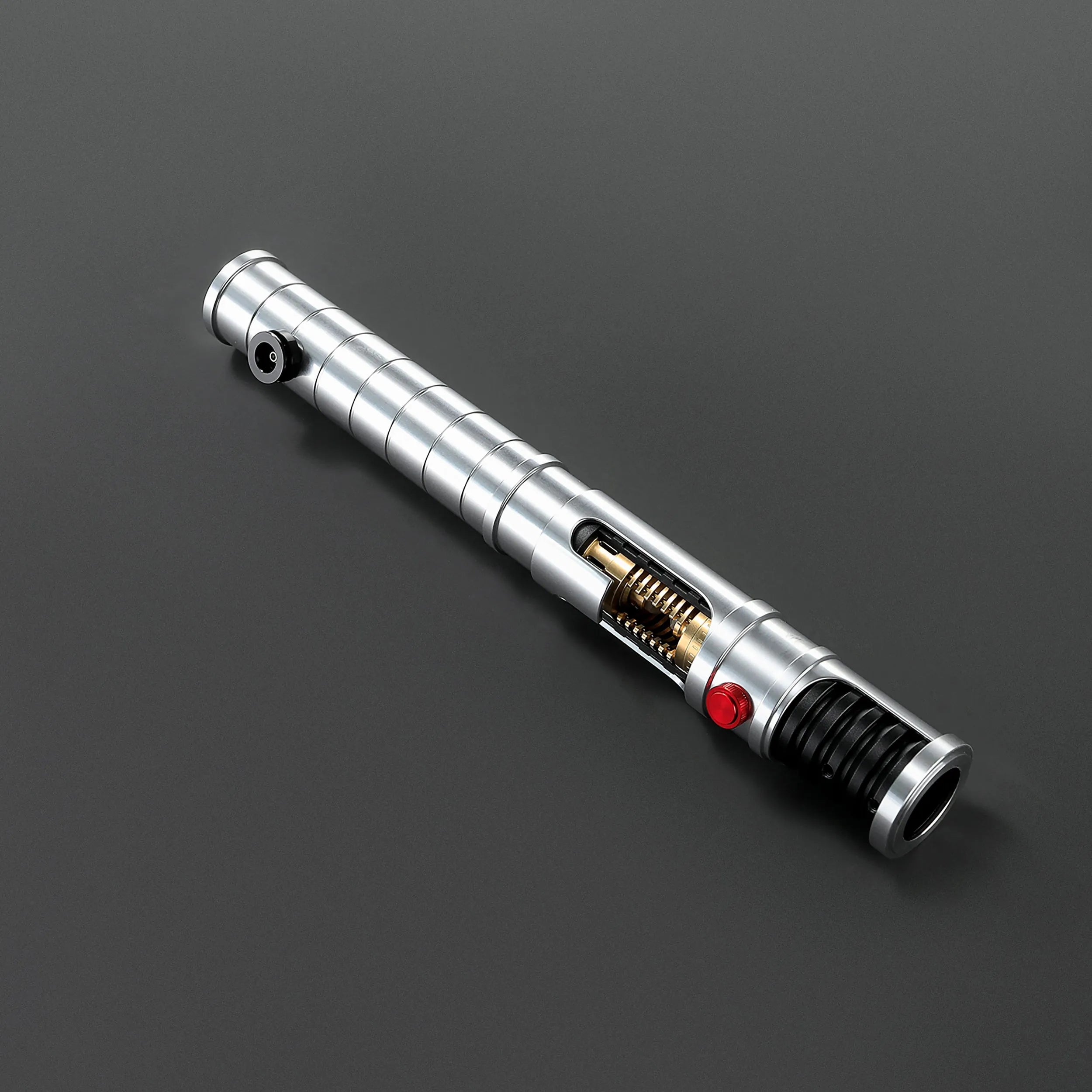 Brushed aluminum Quinlan Vos lightsaber hilt with exposed kyber crystal chamber, red button, and black grip.