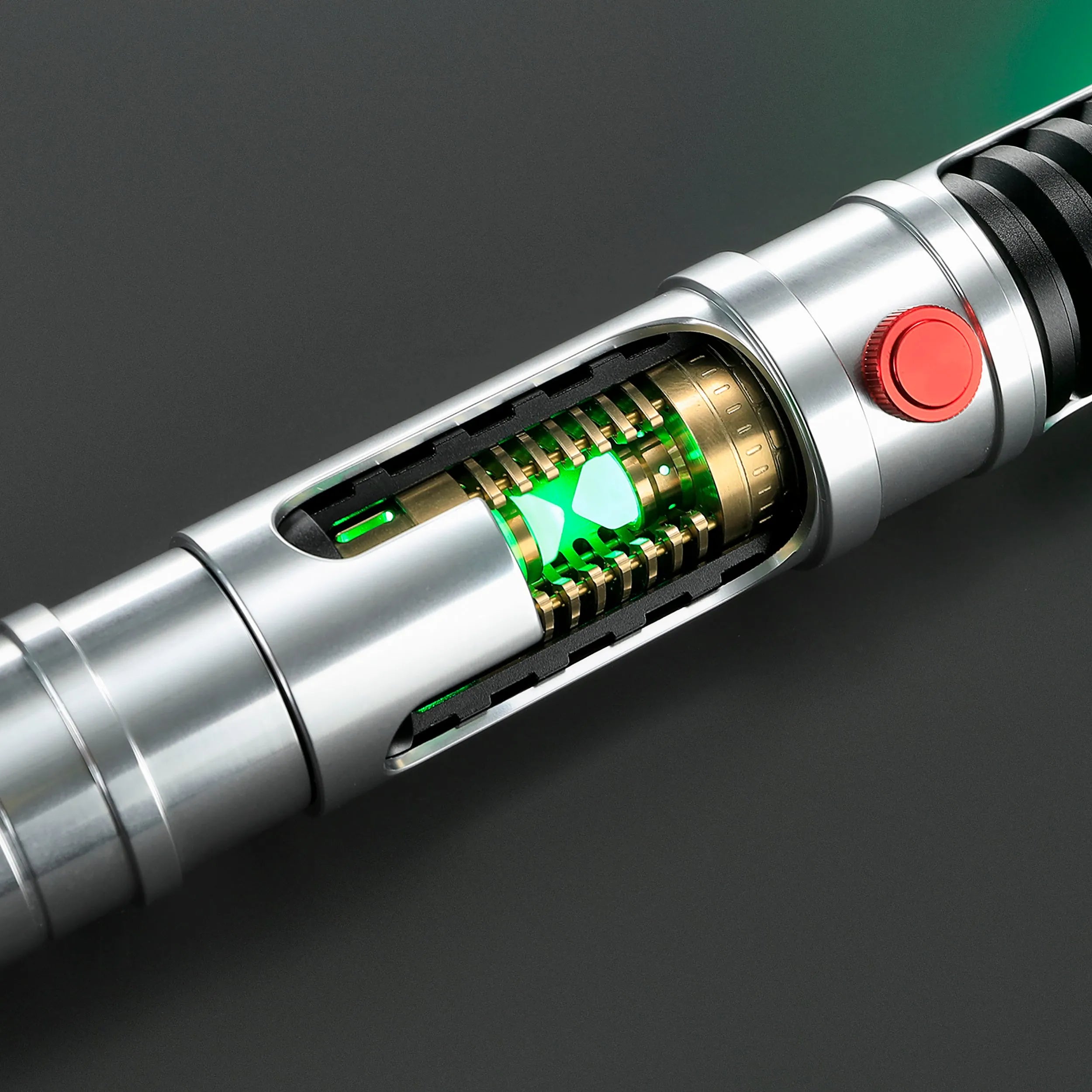 Quinlan Vos Saber: Brushed aluminum hilt with visible green kyber crystal chamber and red activation button.