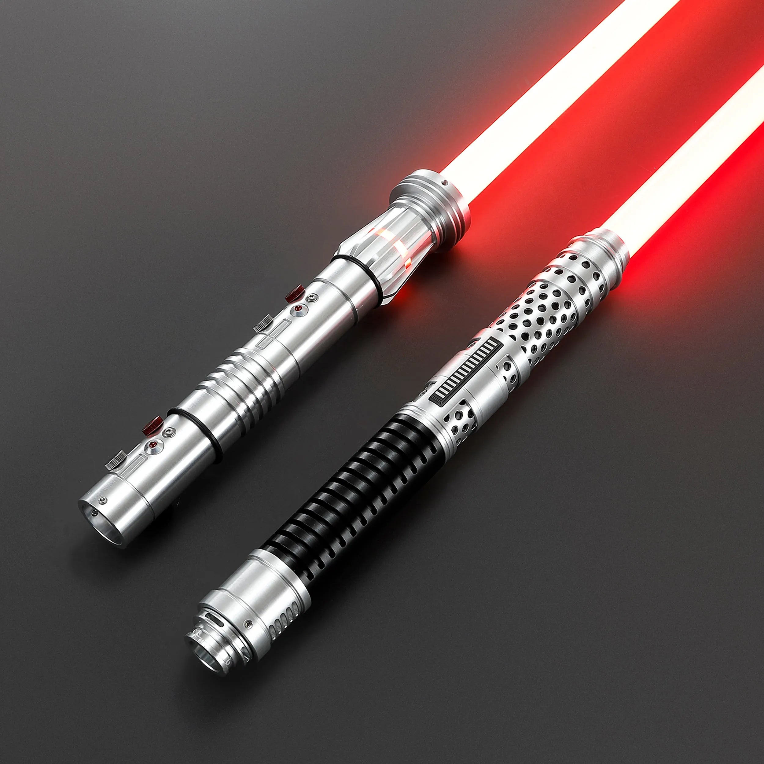 Two brushed silver metal Shadow Lord saber hilts with glowing red blades, one with a black ribbed grip.