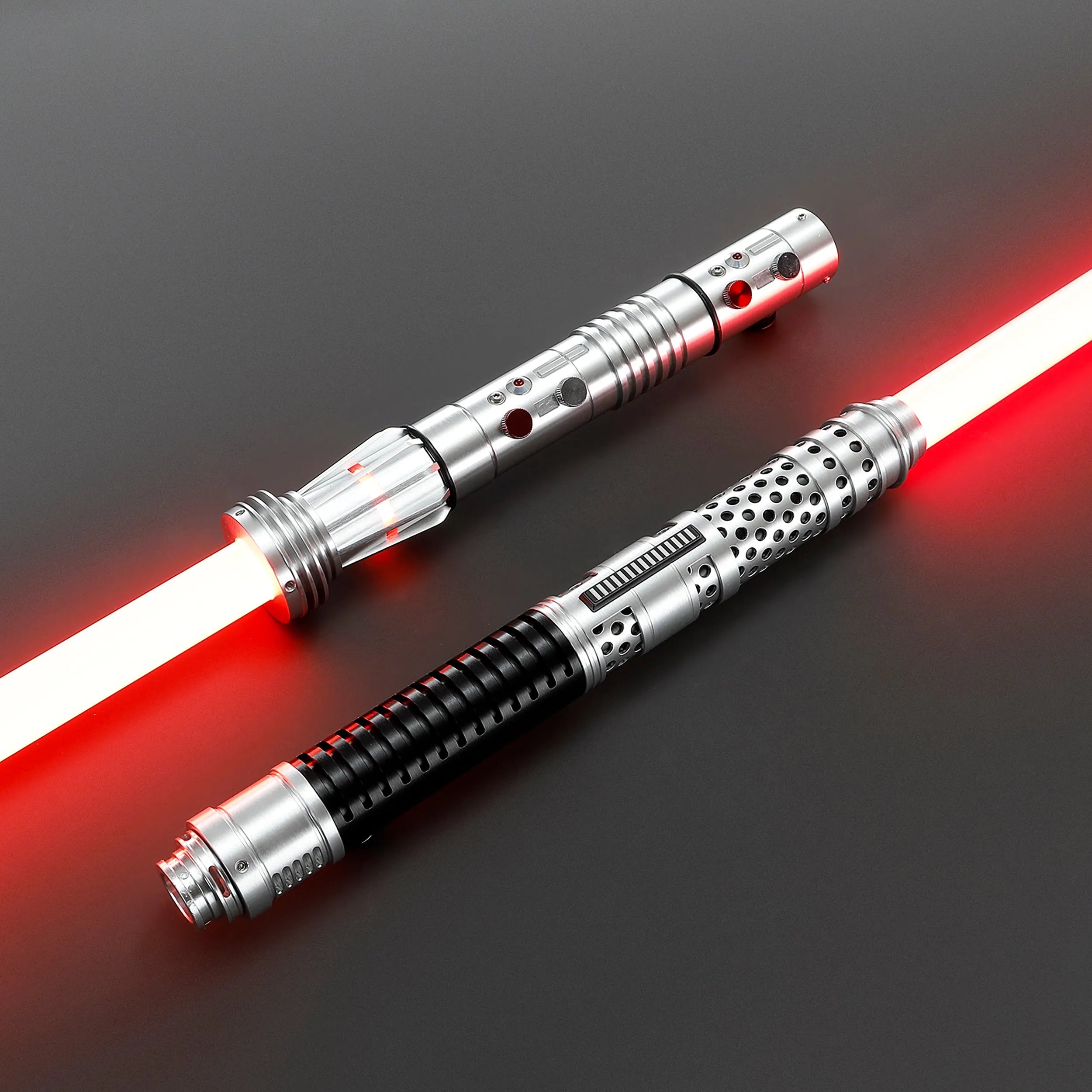 Two brushed silver metal Shadow Lord saber hilts with glowing red polycarbonate blades, designed for dual-blade combat.