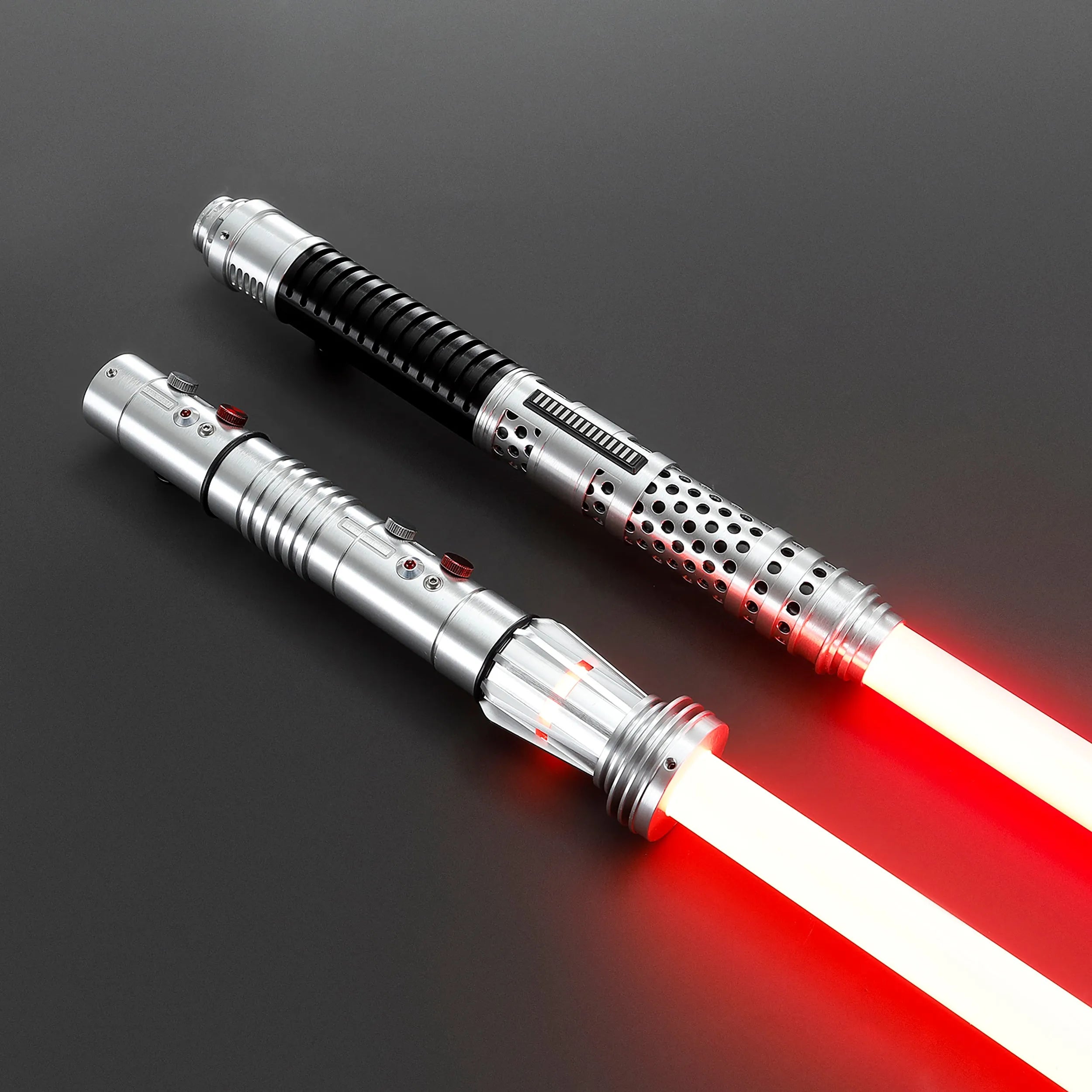 Two brushed silver metal Shadow Lord saber hilts with glowing red polycarbonate blades, designed for dual-wielding.