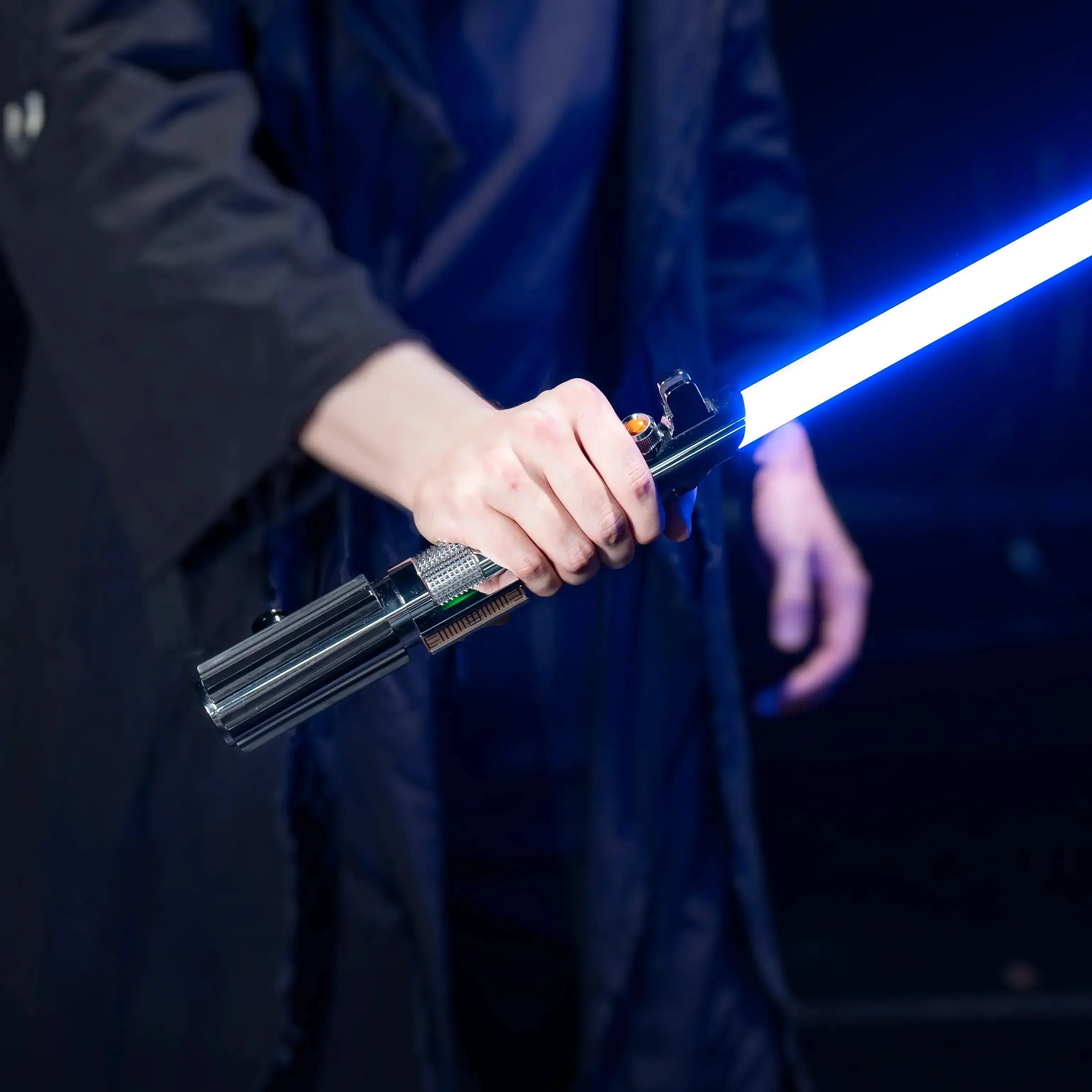 Cosplayer holding anakin lightsaber