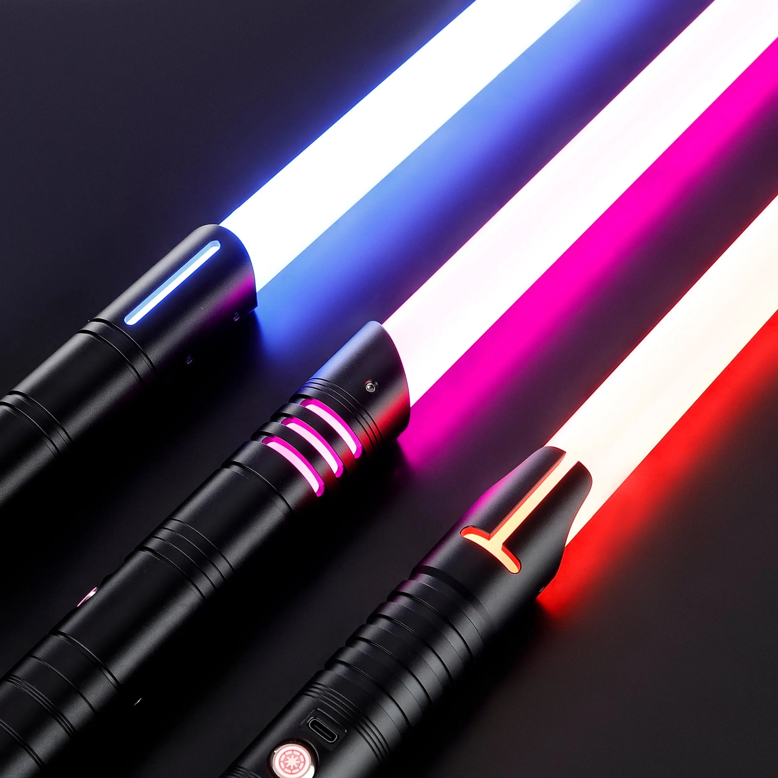 Three black T6 aluminum alloy dueling sabers with glowing blue, pink, and red polycarbonate blades.