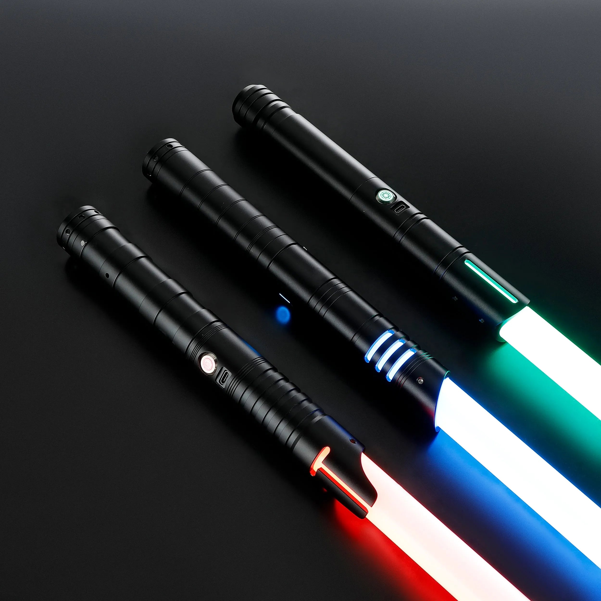 Three black T6 aluminum alloy dueling sabers with glowing red, blue, and green blades.