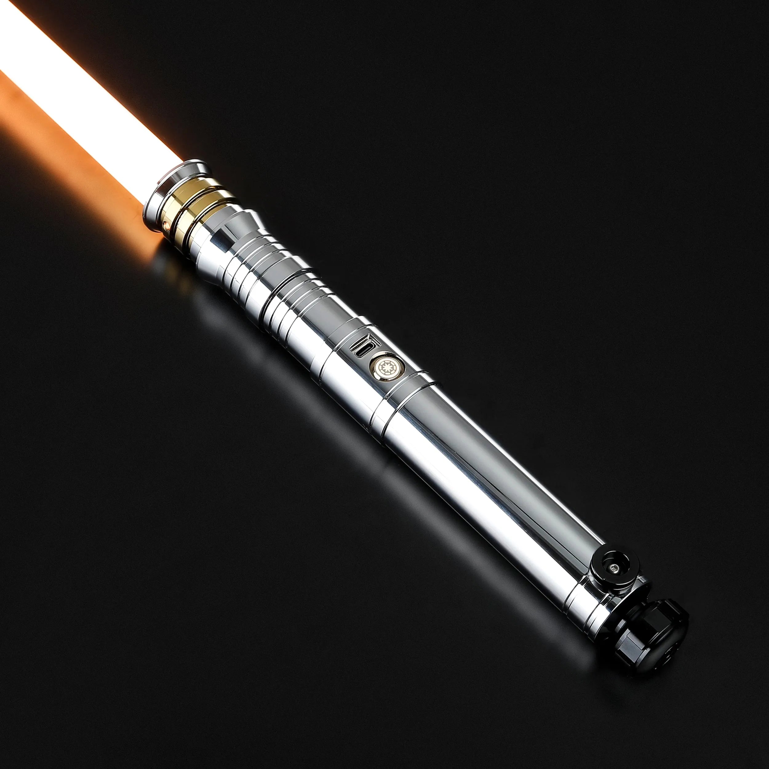 Heavy dueling Darth Revan lightsaber replica with a silver hilt, gold accents, and an orange blade.