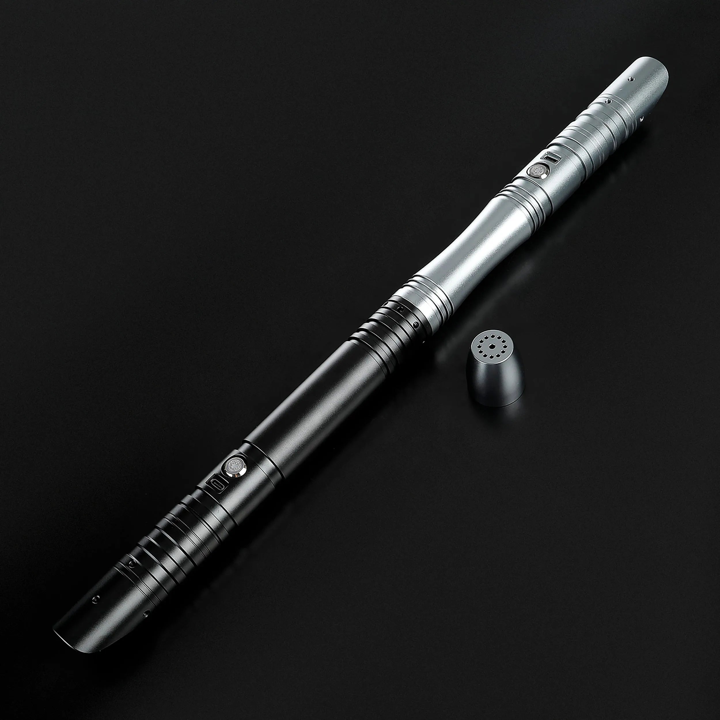 Sleek two-tone gray and black aluminum alloy saber hilt with speaker cap, ready for dueling.
