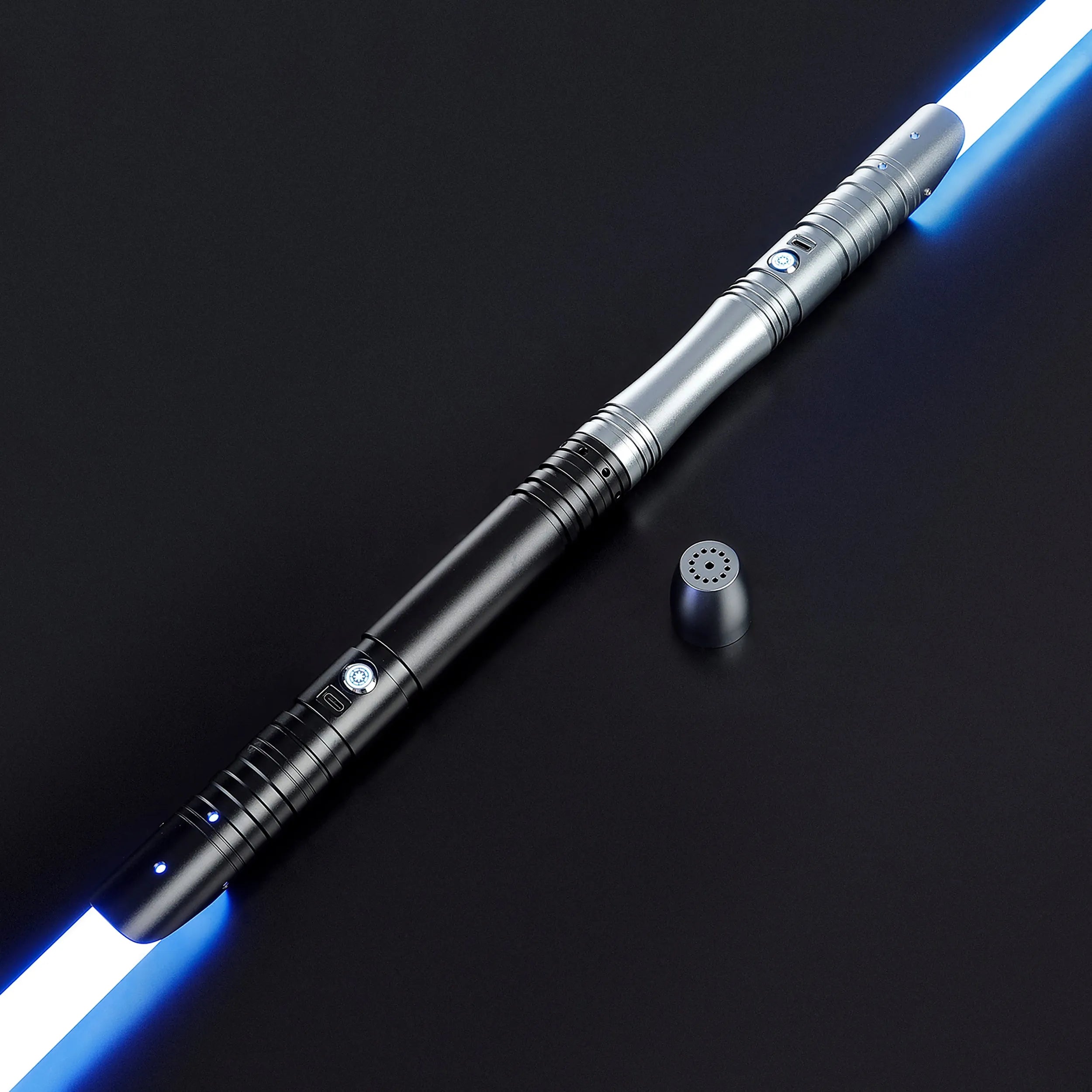 Two-tone black and silver aluminum saber with glowing blue baselit blades, shown with a pommel cap.