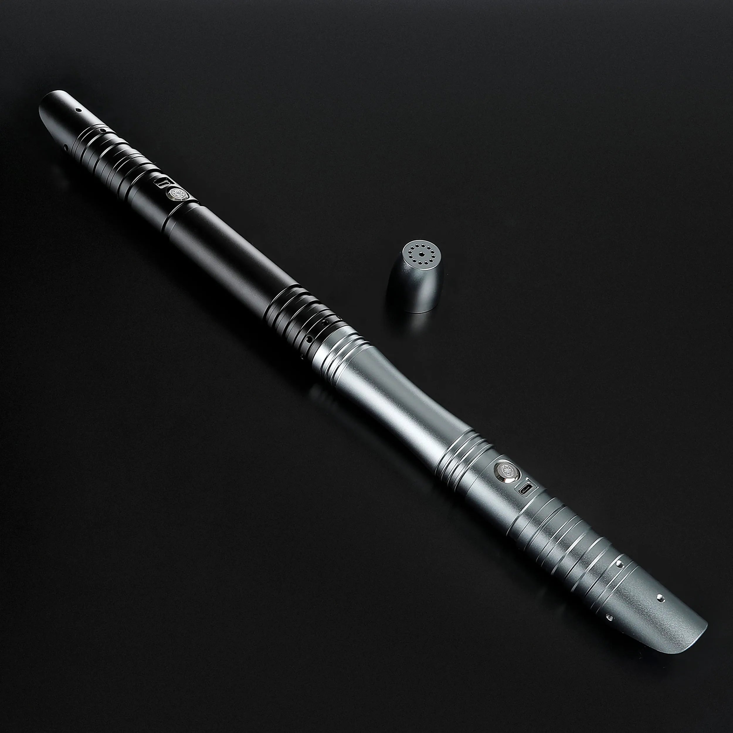 Sleek black and silver T6 aluminum alloy saber hilt with textured grip and speaker cap.