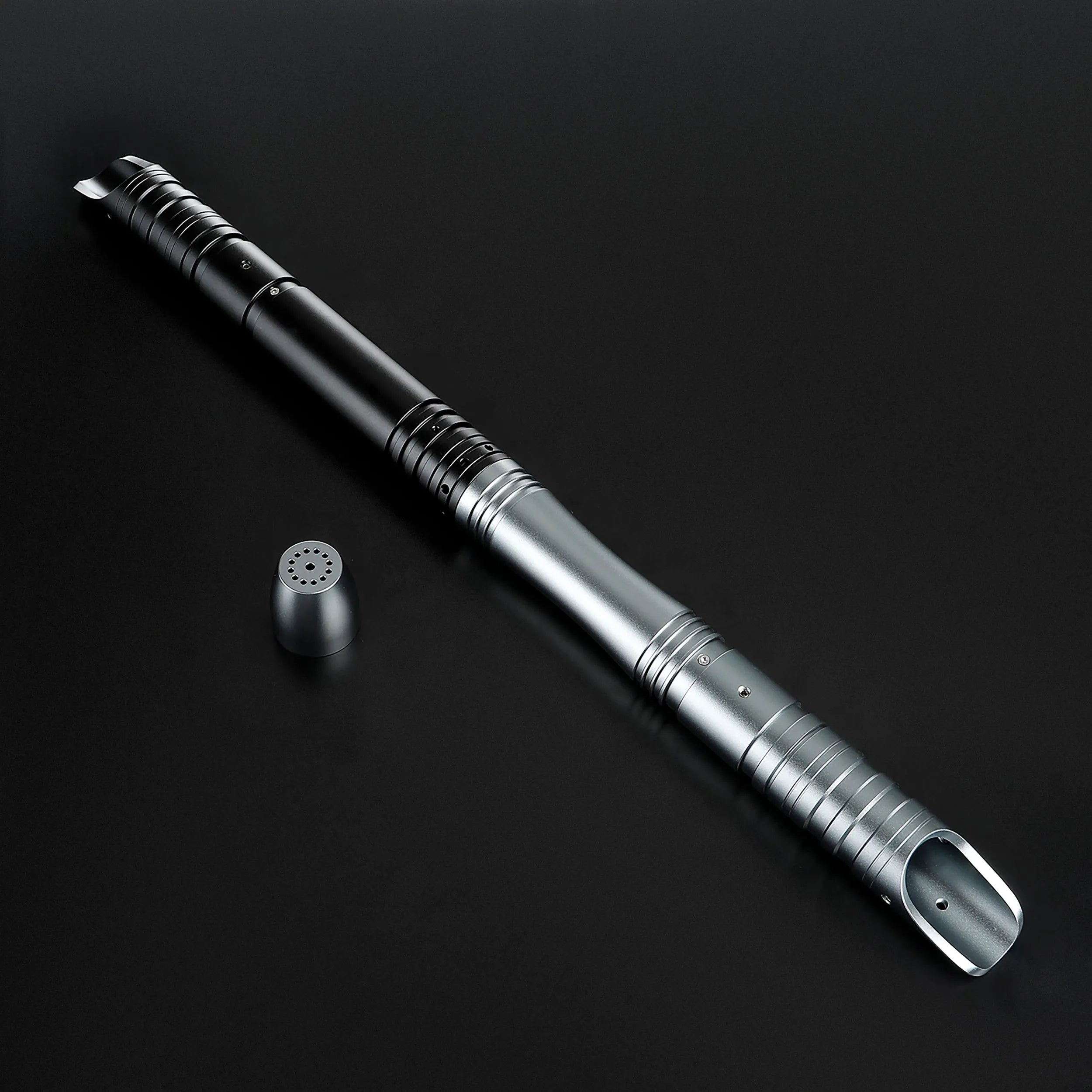 Sleek black and silver aluminum alloy saber hilt with a speaker cap, ready for a baselit blade.