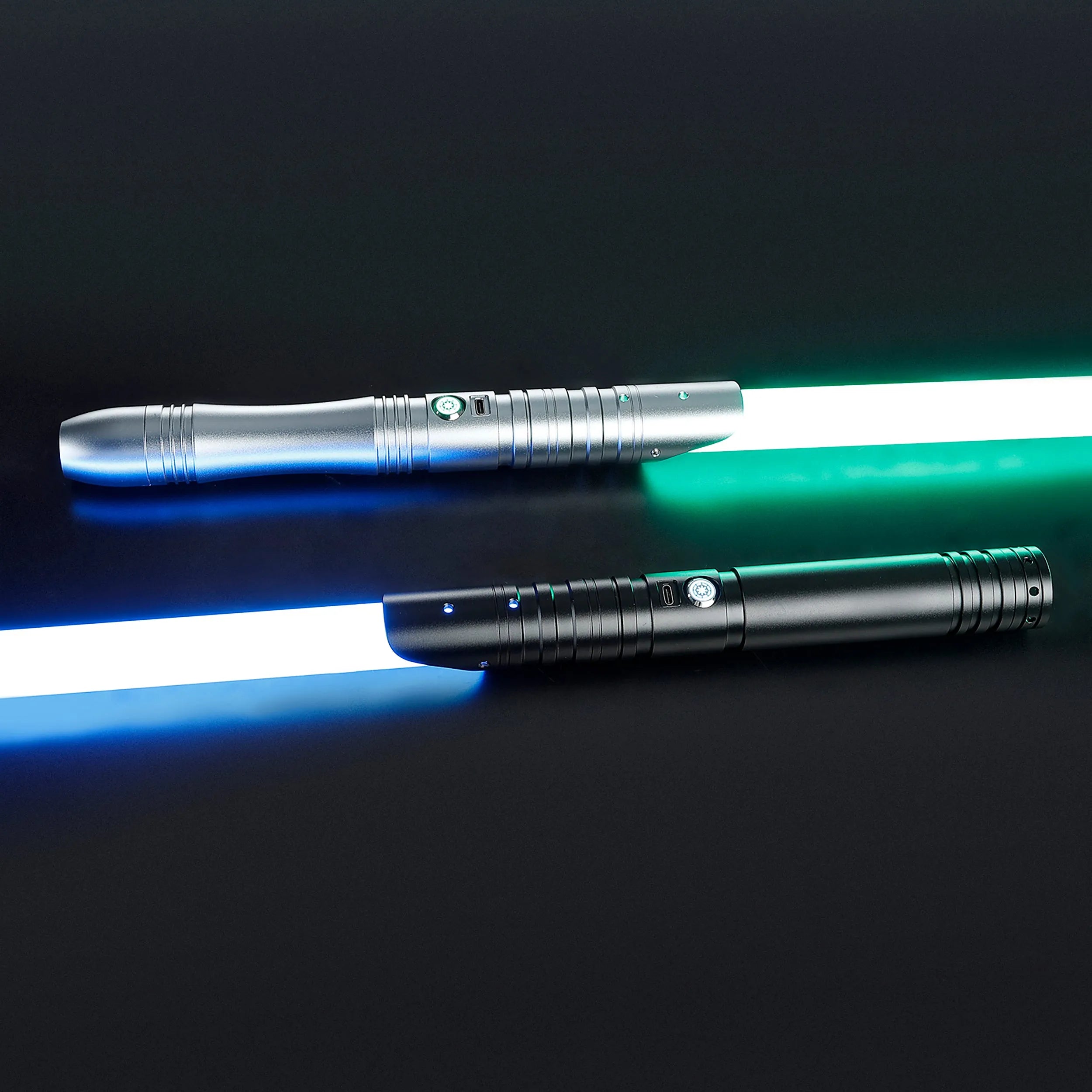 Two illuminated sabers: a silver hilt with a green blade and a black hilt with a blue blade.