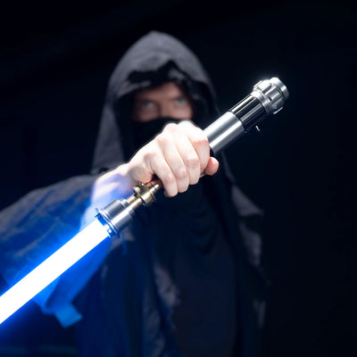 Person in a dark hooded cloak holding a glowing blue T6 aluminum alloy Obi-Wan lightsaber with a duel-ready polycarbonate blade.