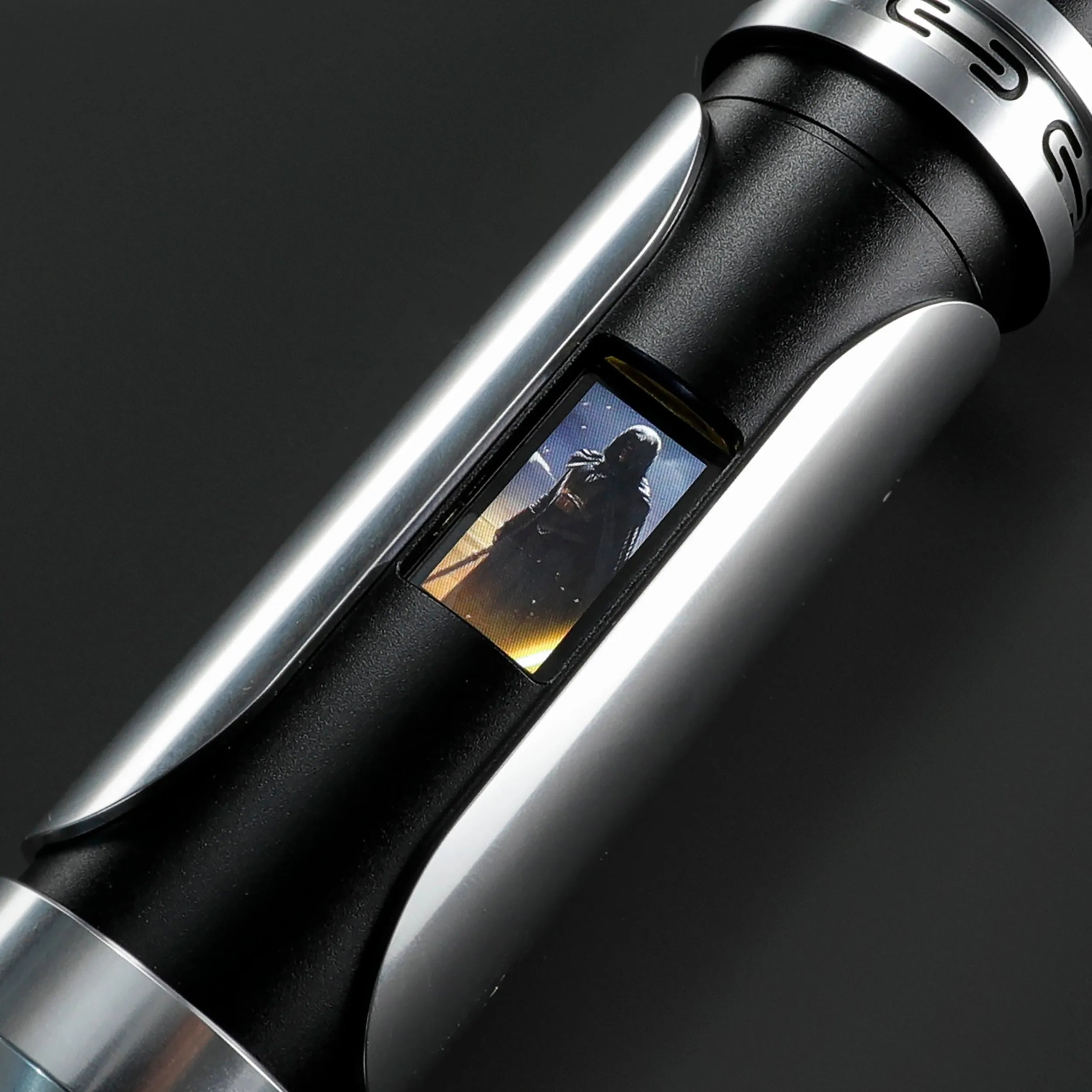 Paragon Xenopixel V3 saber hilt, black and silver aircraft-grade aluminum, with an OLED display showing a character.