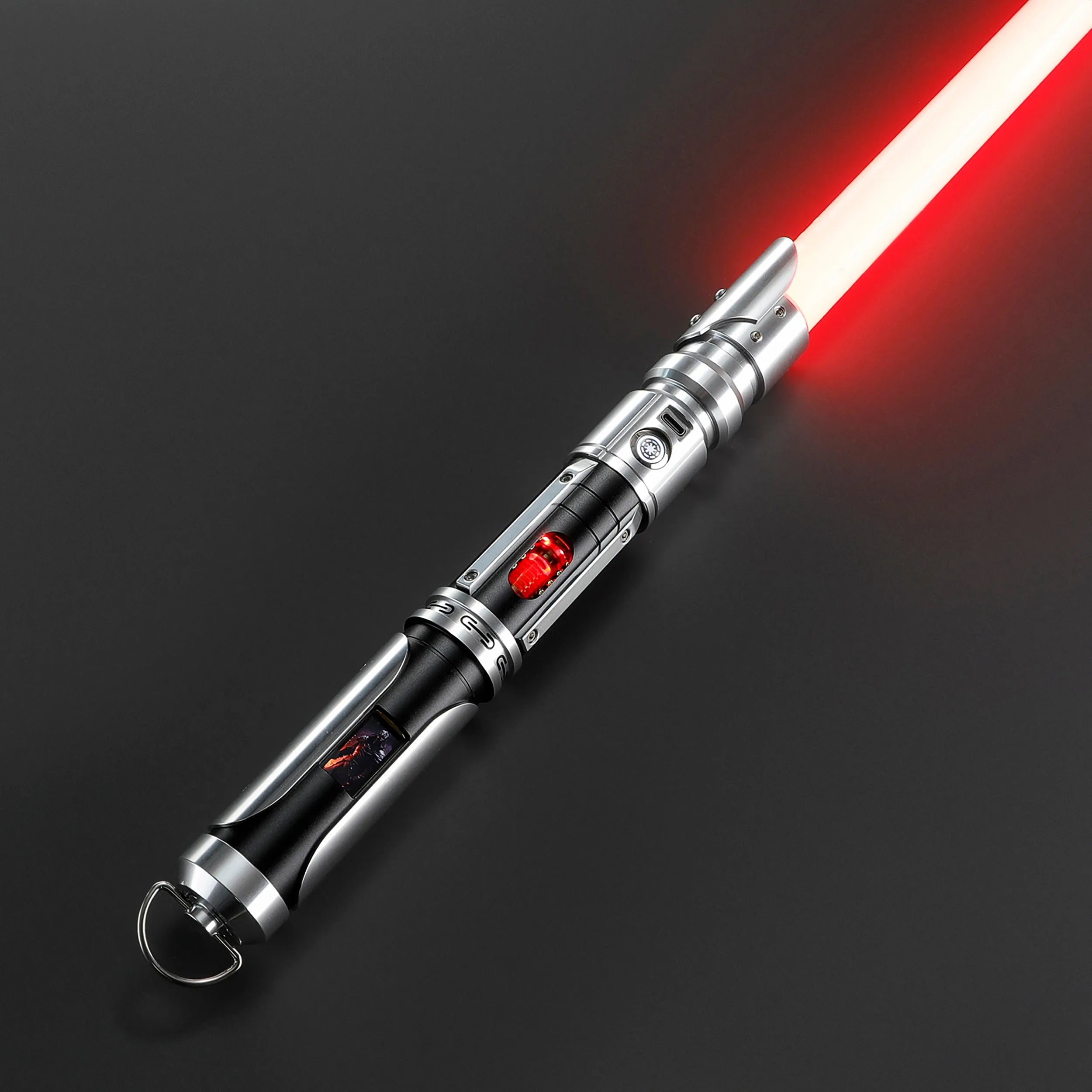 Paragon Xenopixel V3 saber with red blade, polished silver and black aircraft-grade aluminum hilt, exposed kyber crystal.