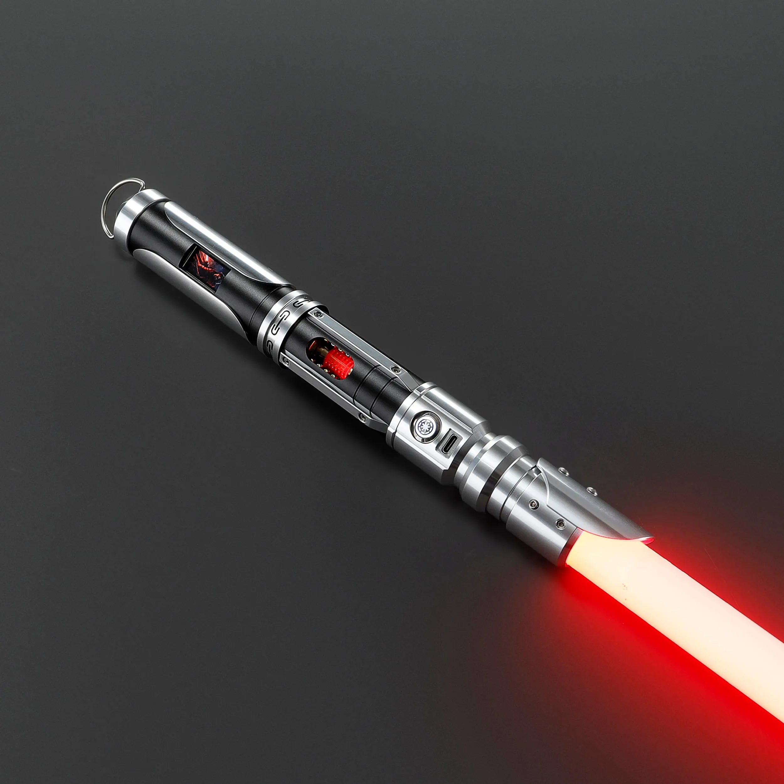 Paragon Xenopixel V3 saber with polished silver and black aircraft-grade aluminum, exposed kyber crystal, and red blade.