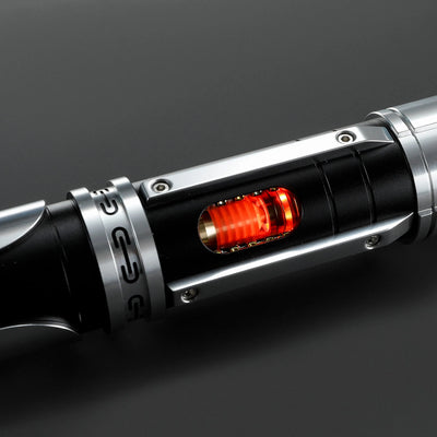 Paragon Xenopixel V3 saber hilt with exposed, glowing red kyber crystal core, crafted from black and silver aircraft-grade aluminum.