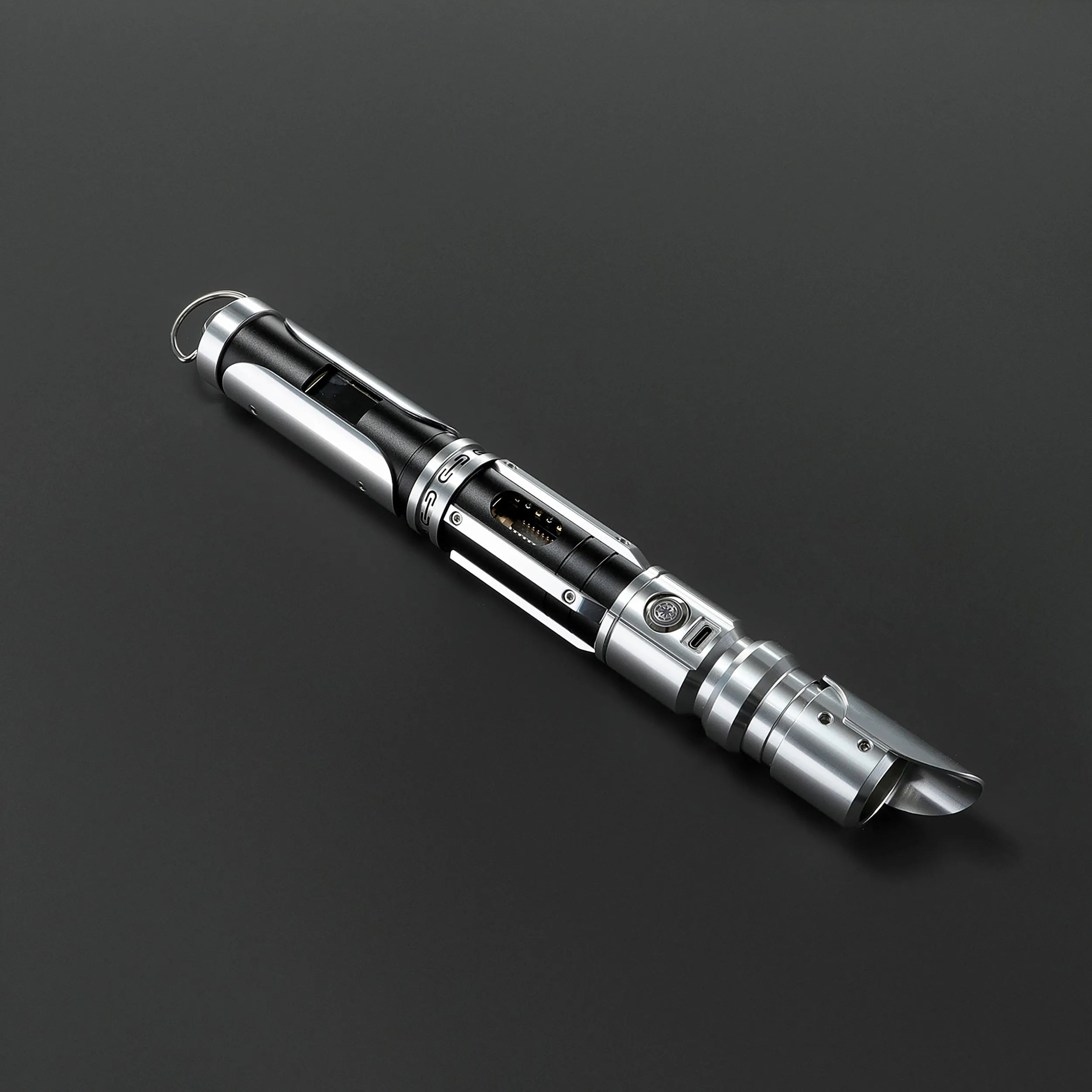 Paragon Xenopixel V3 saber hilt, polished silver and deep black aircraft-grade aluminum, exposed kyber crystal chamber.