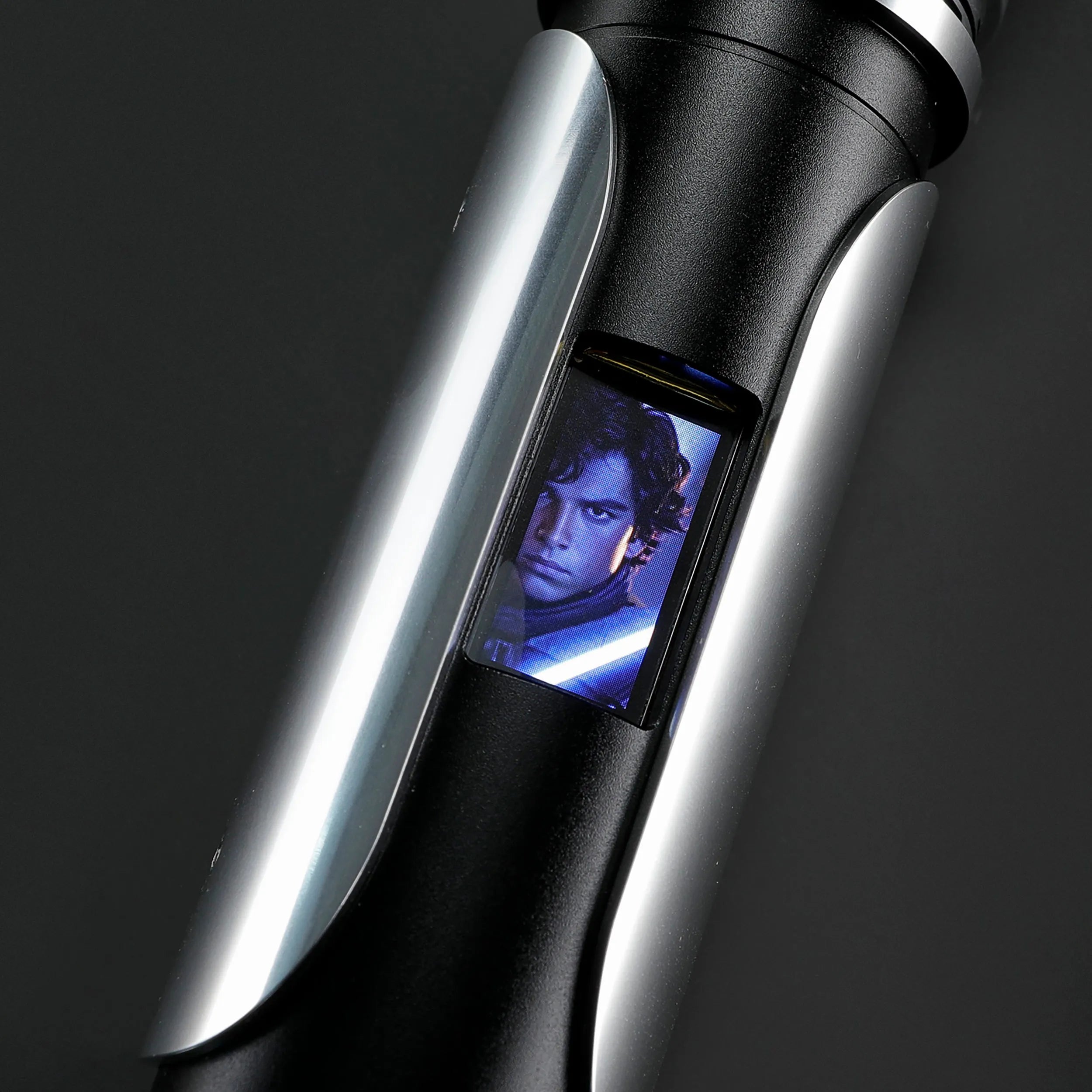 Paragon Xenopixel V3 saber hilt, black and silver aircraft-grade aluminum, with an OLED display showing a character.