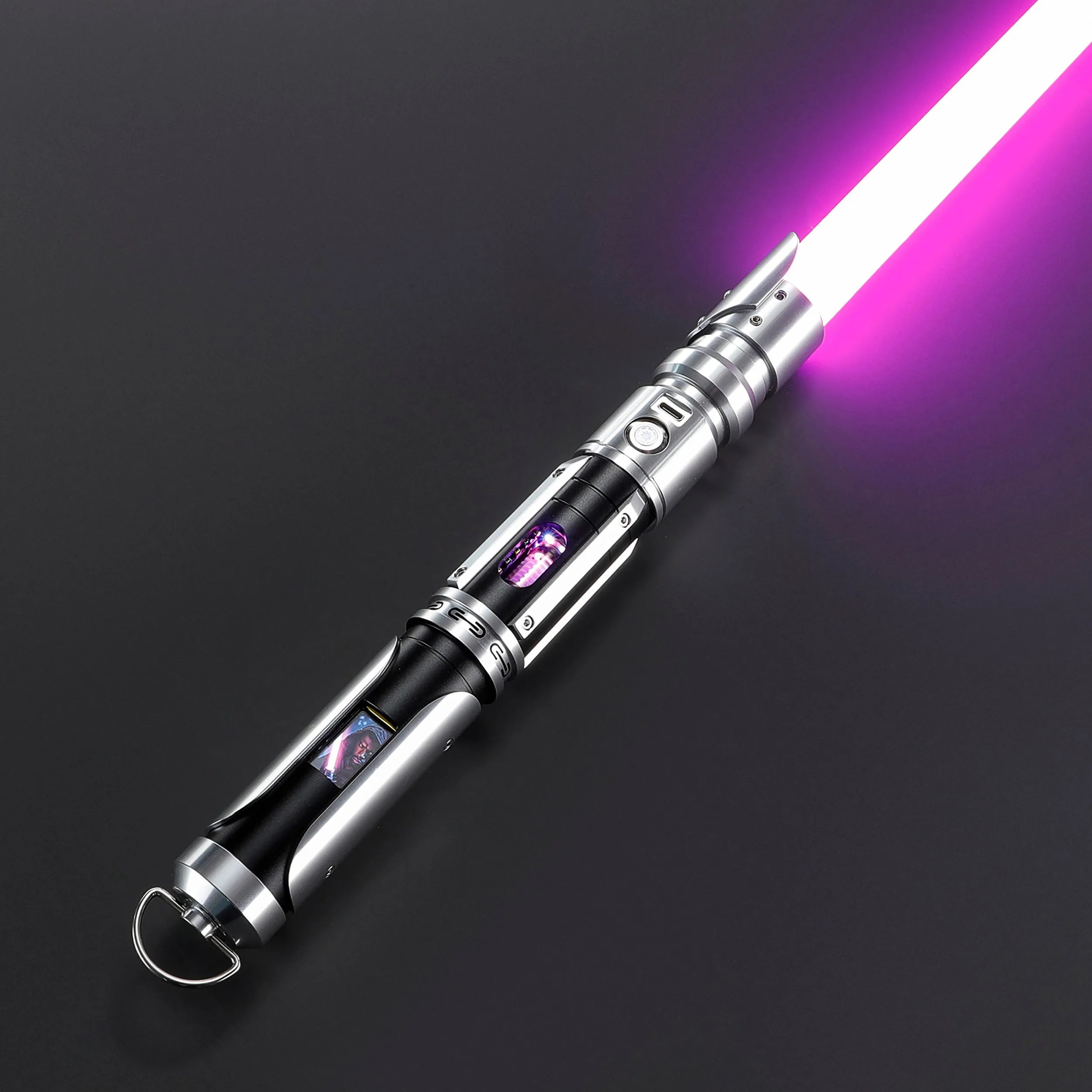 Paragon Xenopixel V3 saber with a glowing purple blade, exposed kyber crystal, and OLED display, crafted from silver and black aircraft-grade aluminum.