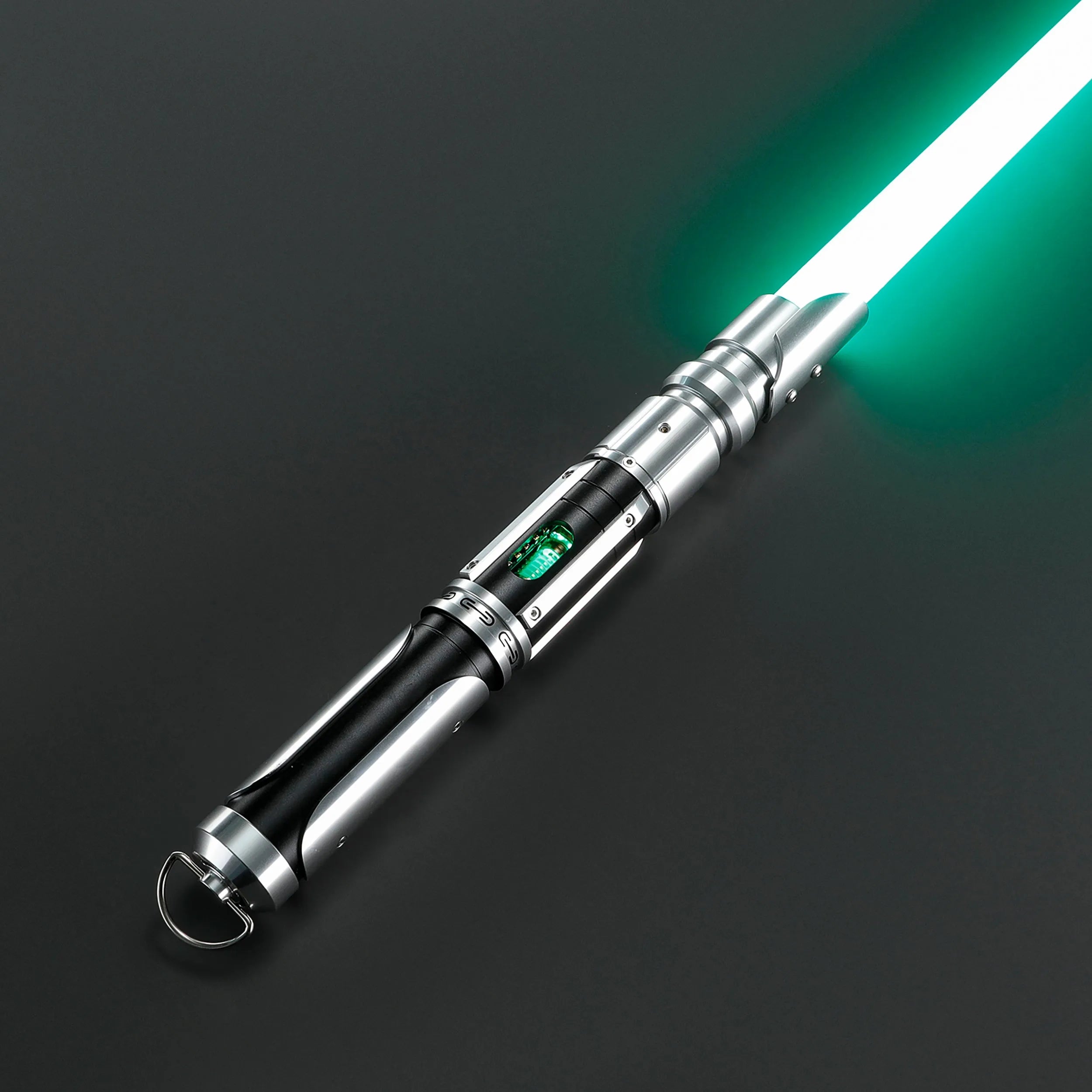 Paragon Xenopixel V3 saber with polished silver and black aircraft-grade aluminum hilt, green blade, and exposed kyber crystal.