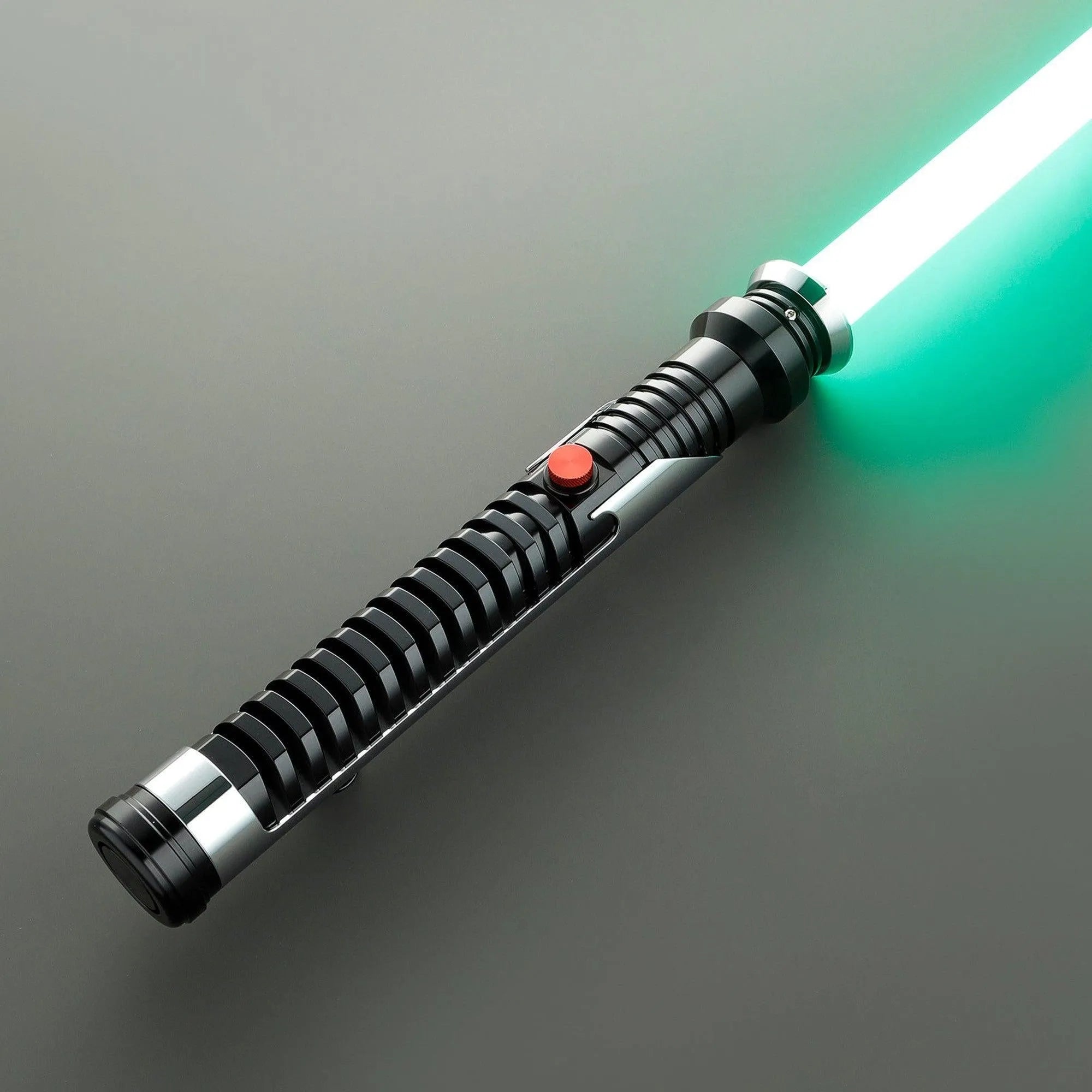 Qui-Gon Jinn's black and silver T60 aluminum lightsaber with a glowing green polycarbonate blade and red activation button.