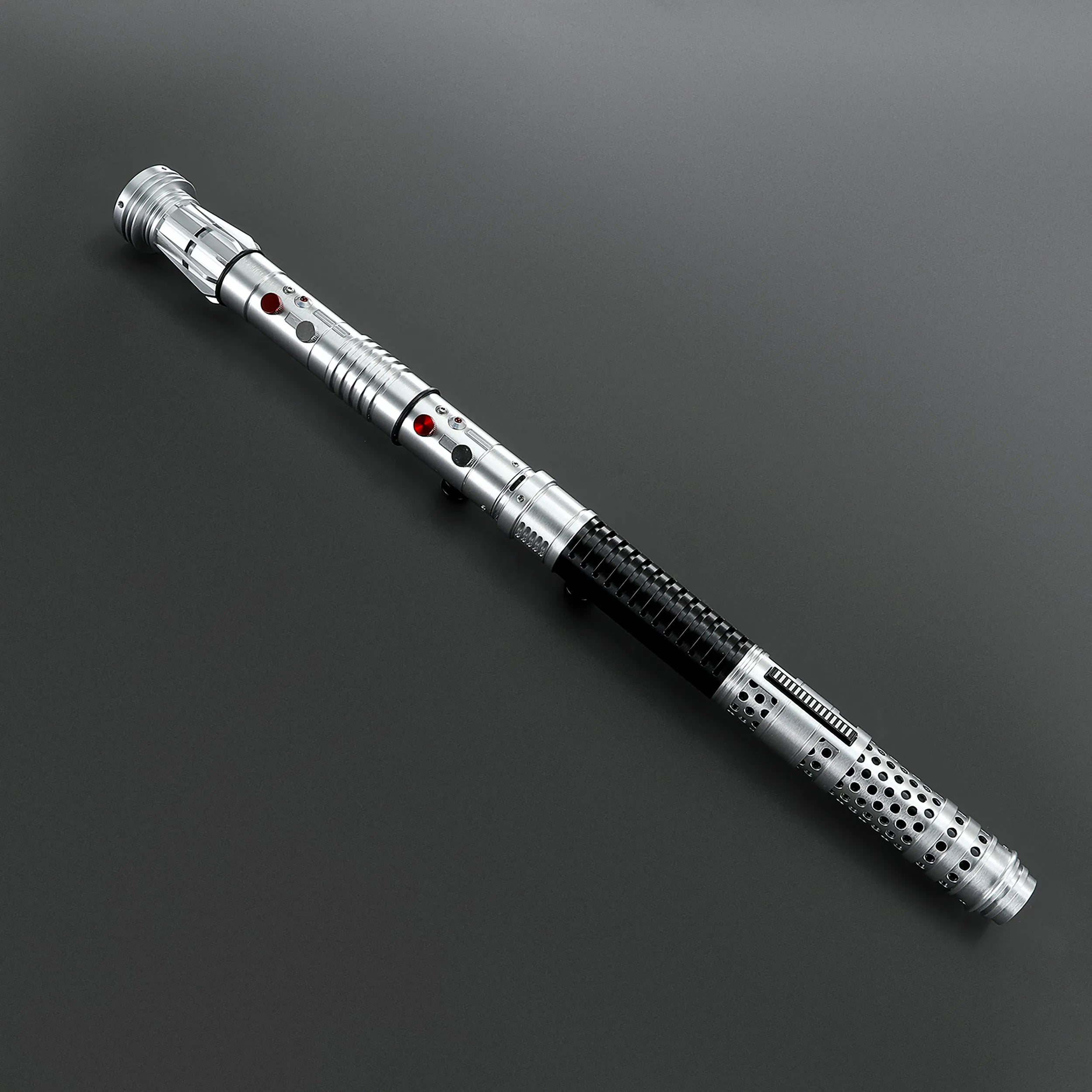 Brushed silver metal Shadow Lord saber staff with black grip and red activation buttons on a dark background.