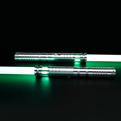Two silver T6 aluminum Sol lightsabers with glowing green polycarbonate blades on a black background.