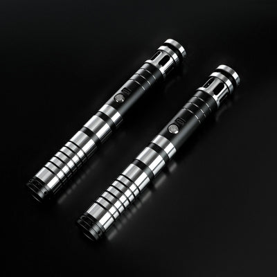 Two Sol lightsaber hilts made of sleek black and silver T6 aircraft aluminum on a dark background.