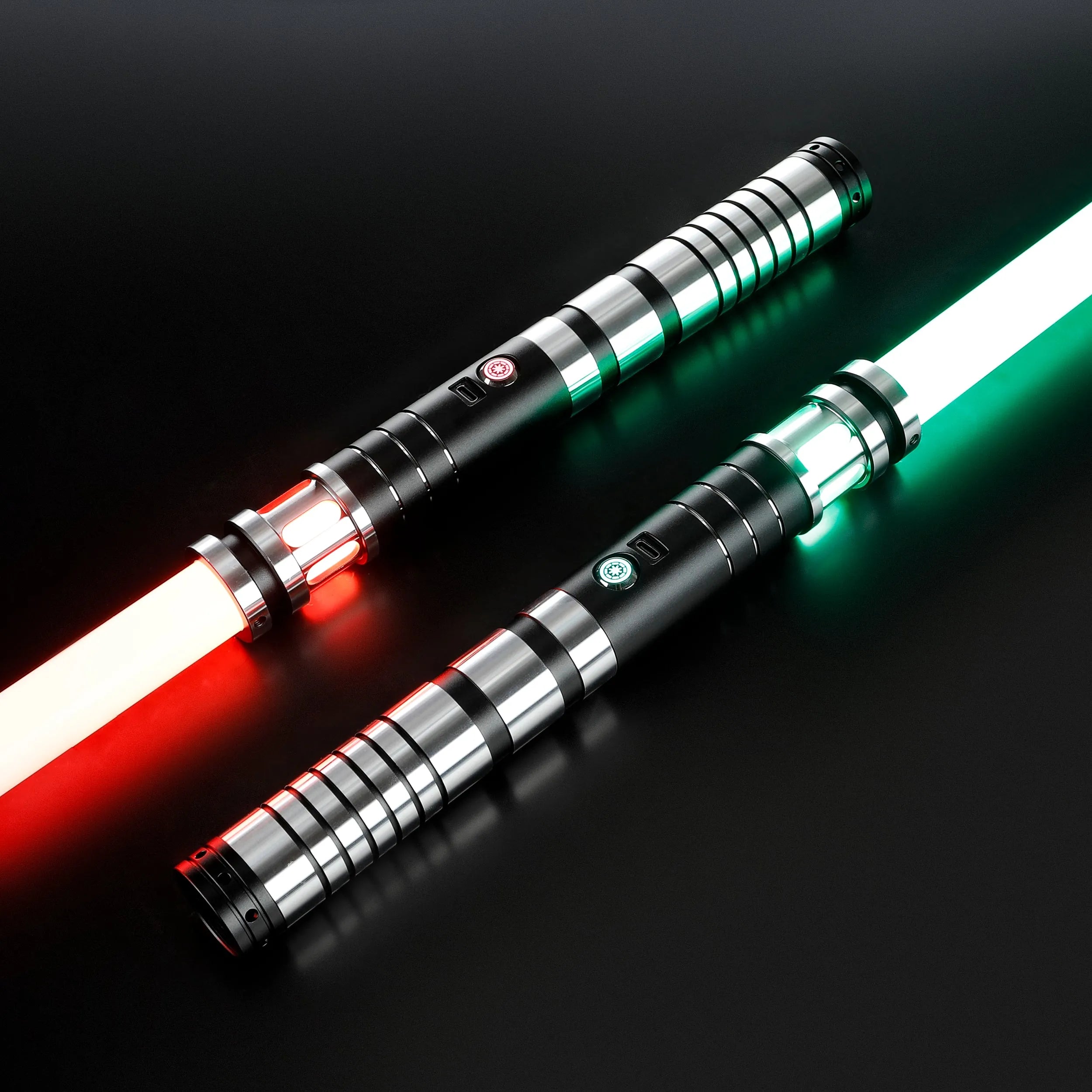 Two Sol lightsabers with black and silver aluminum hilts, featuring glowing red and green polycarbonate blades.