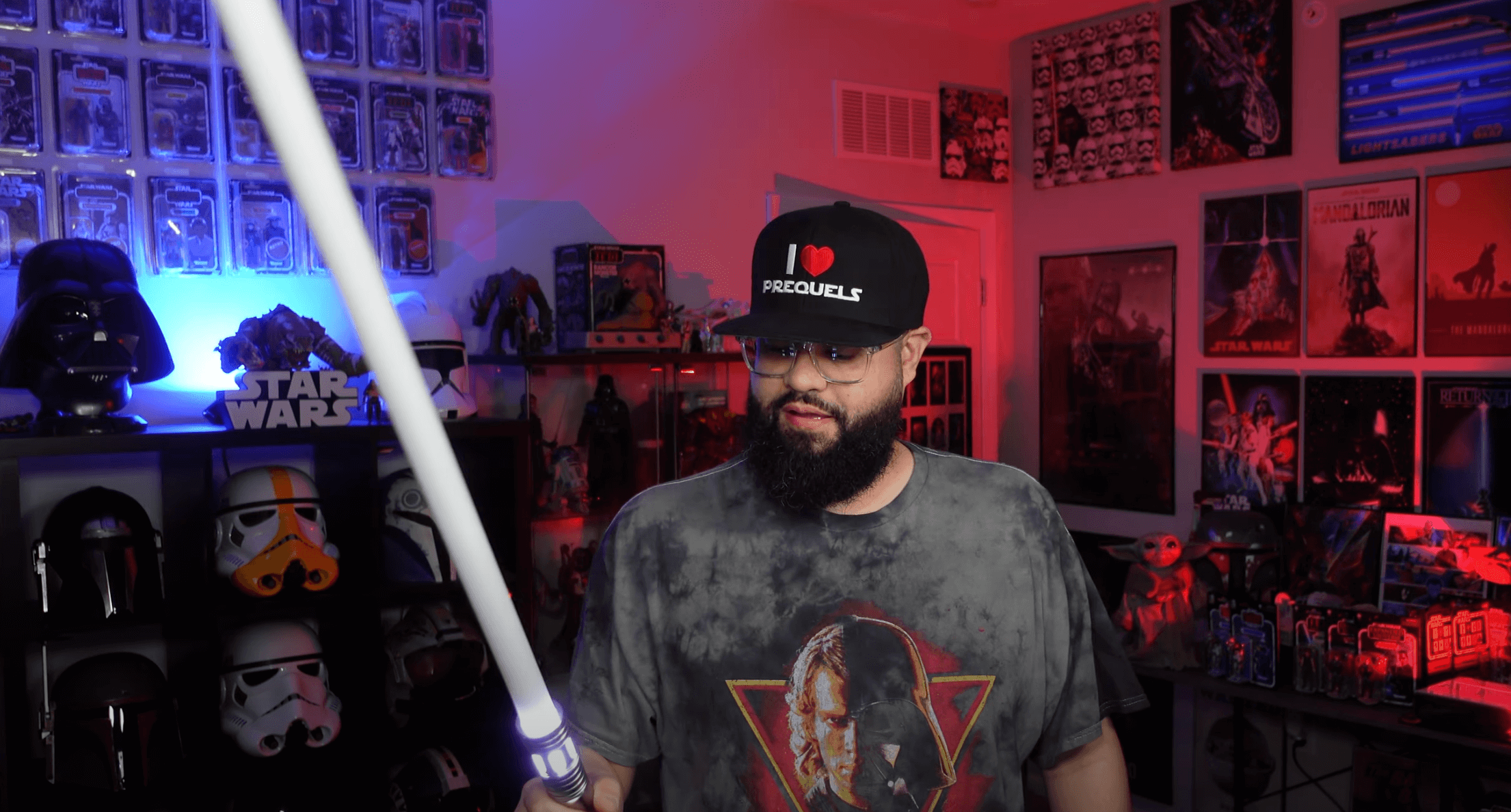 A star wars influencer holding a saberspro lightsaber.